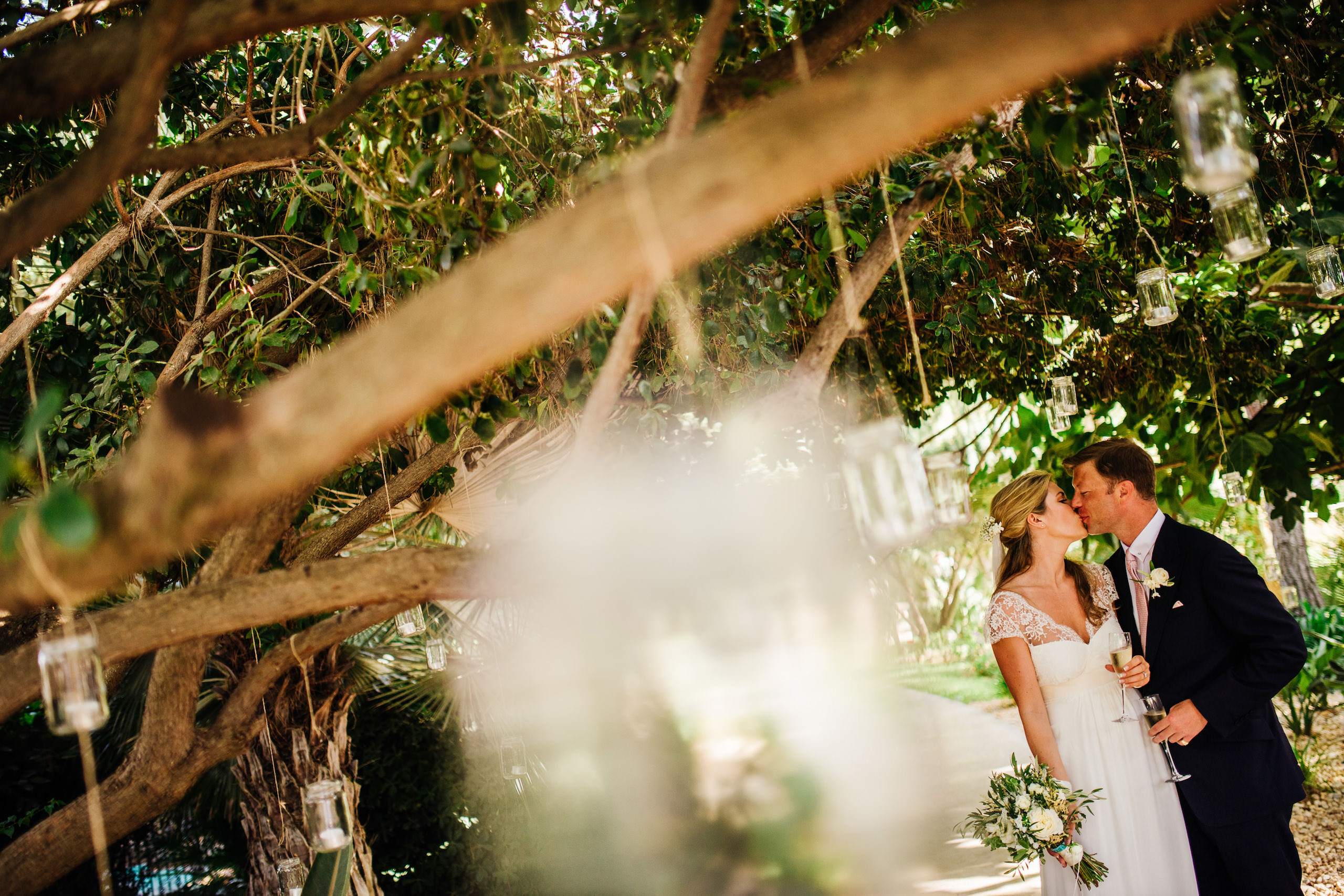 Wedding in Portugal | Caroline & Justin 1 Caroline and Justin kissing beneath the trees at their wedding in Portugal