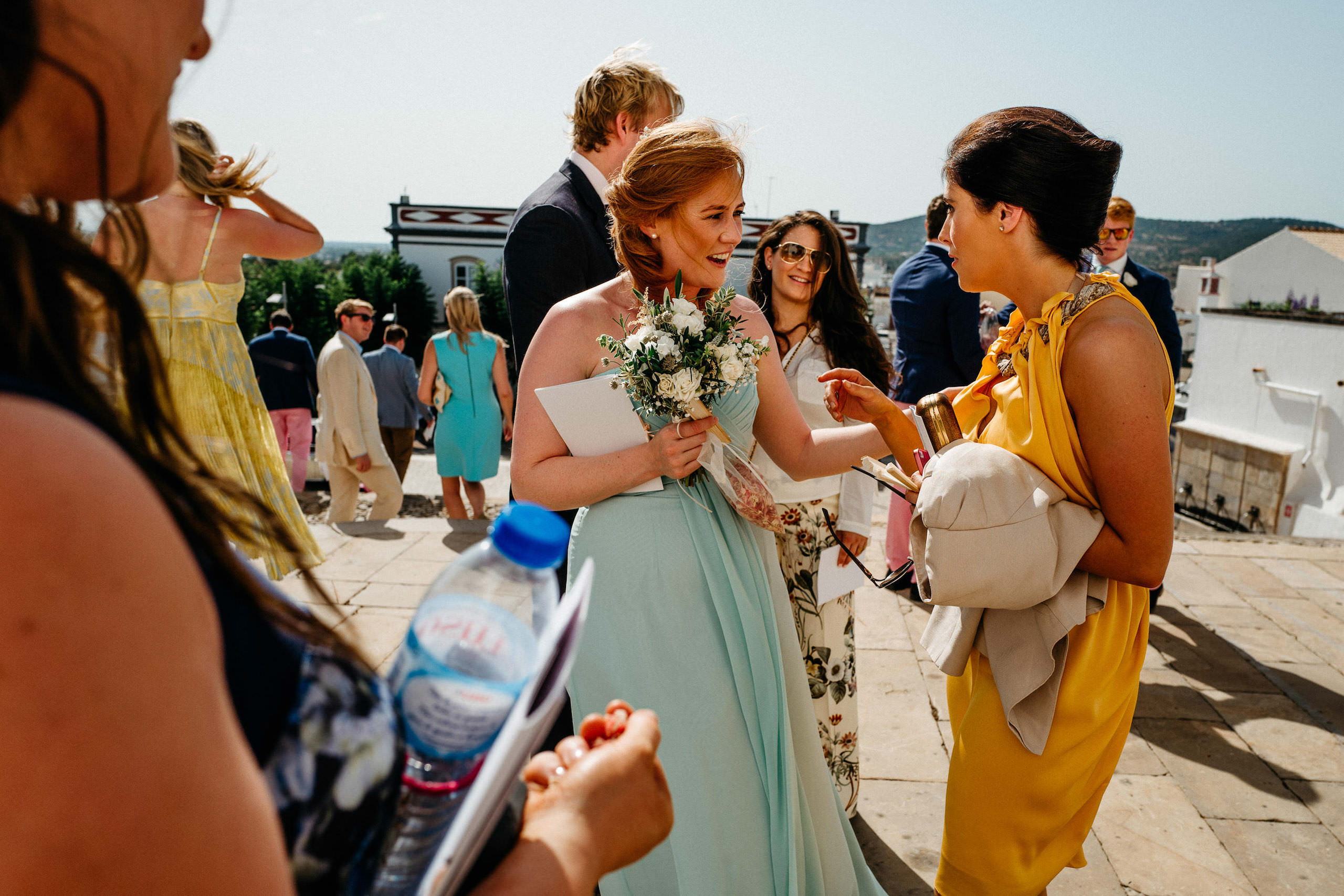 Wedding in Portugal | Caroline & Justin 61 Wedding guests talking outside the church in Estoi