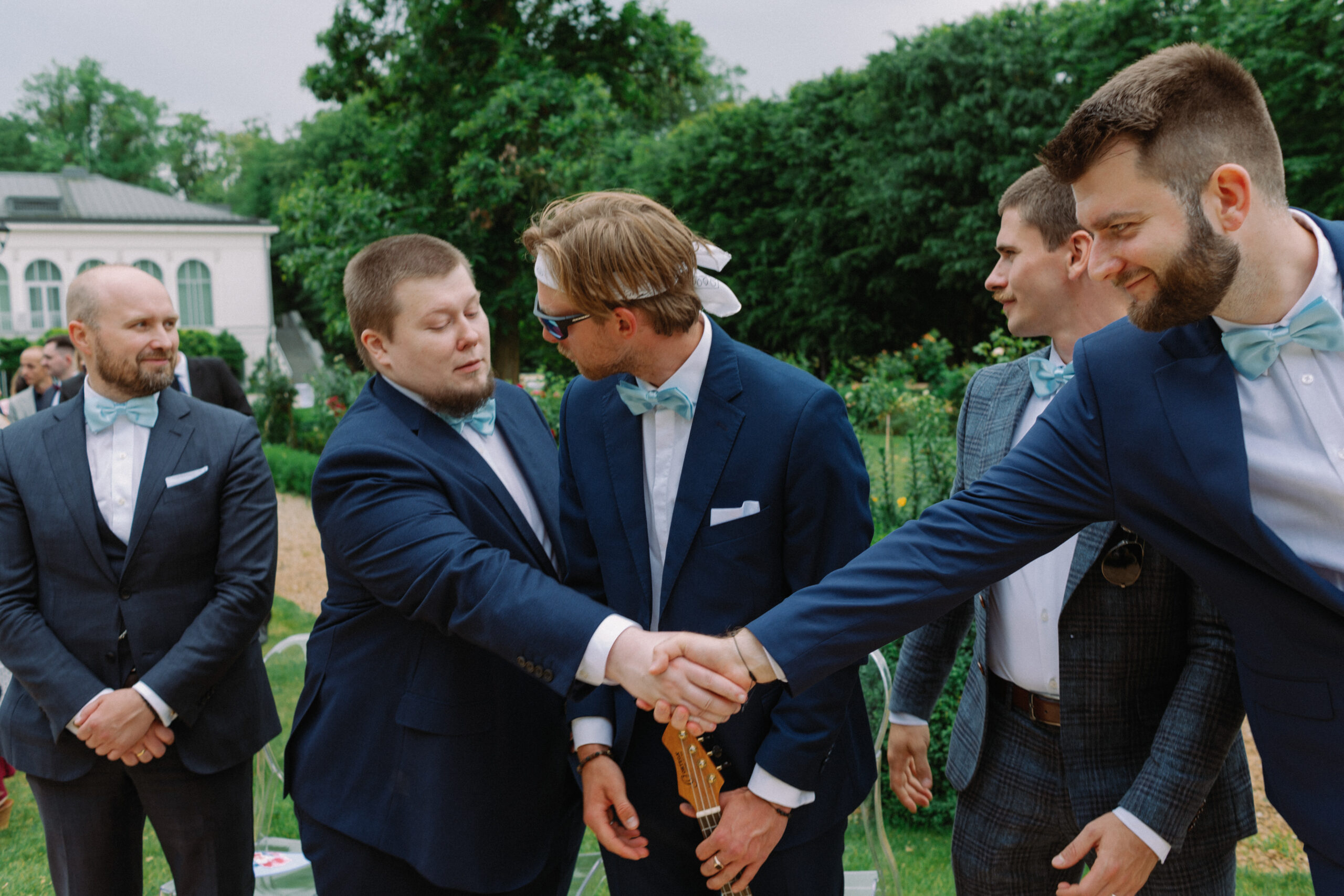 Goście podają sobie dłonie podczas ceremonii